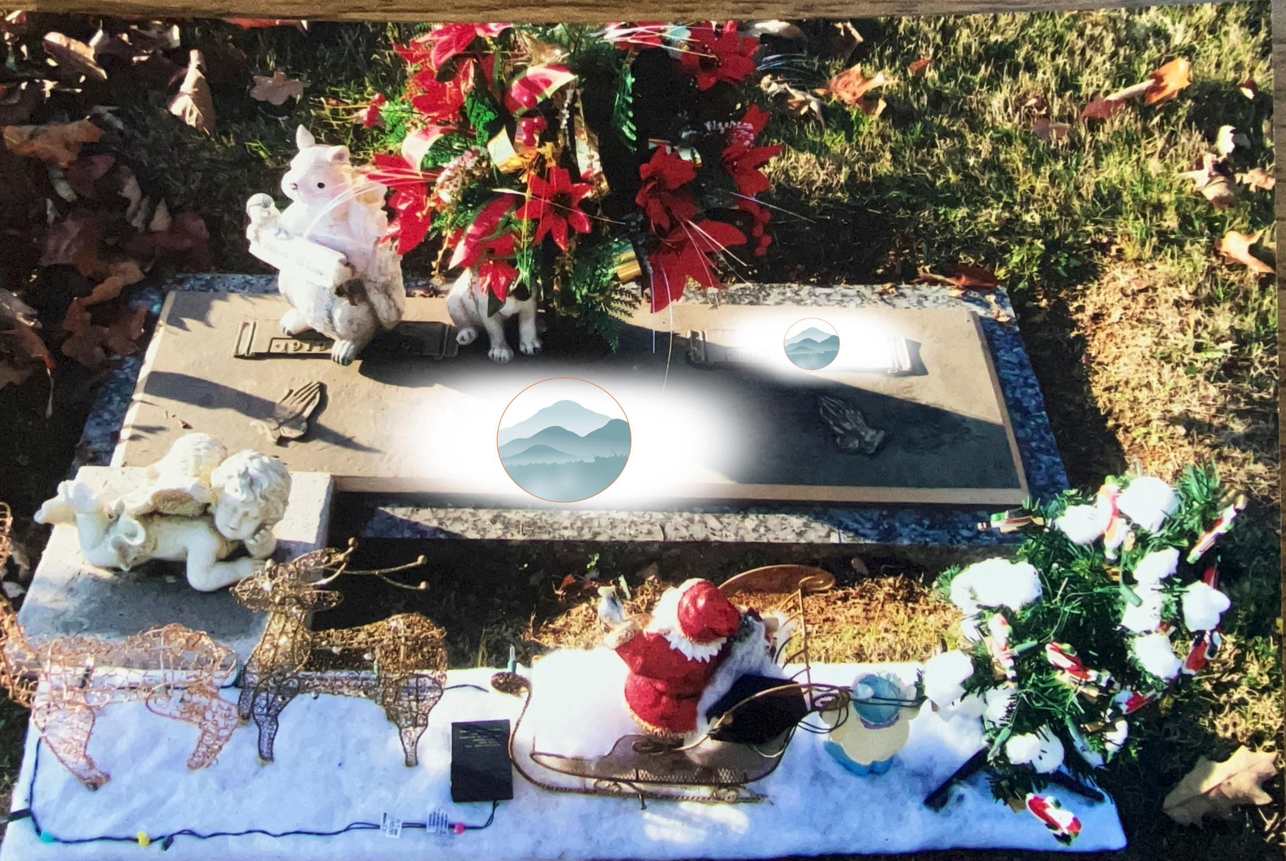 A grave decorated for Christmas with decorations including a Santa figure, angel figurines, and metal reindeer and angel ornaments, along with artificial poinsettia and cotton plant arrangements.