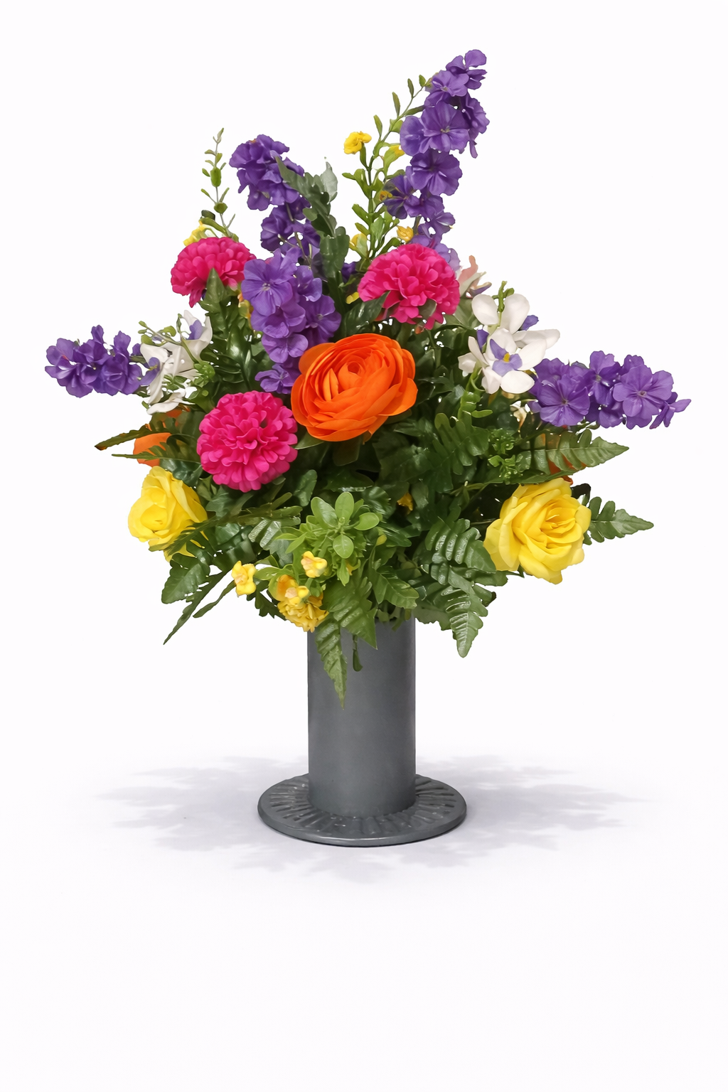 Colorful artificial flower bouquet with purple, pink, yellow, orange, and white flowers in a gray vase.