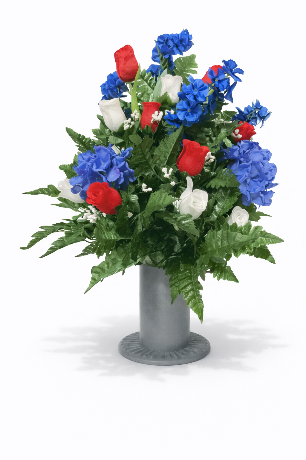 Artificial floral arrangement with red, white, and blue flowers in a gray vase on a white background.