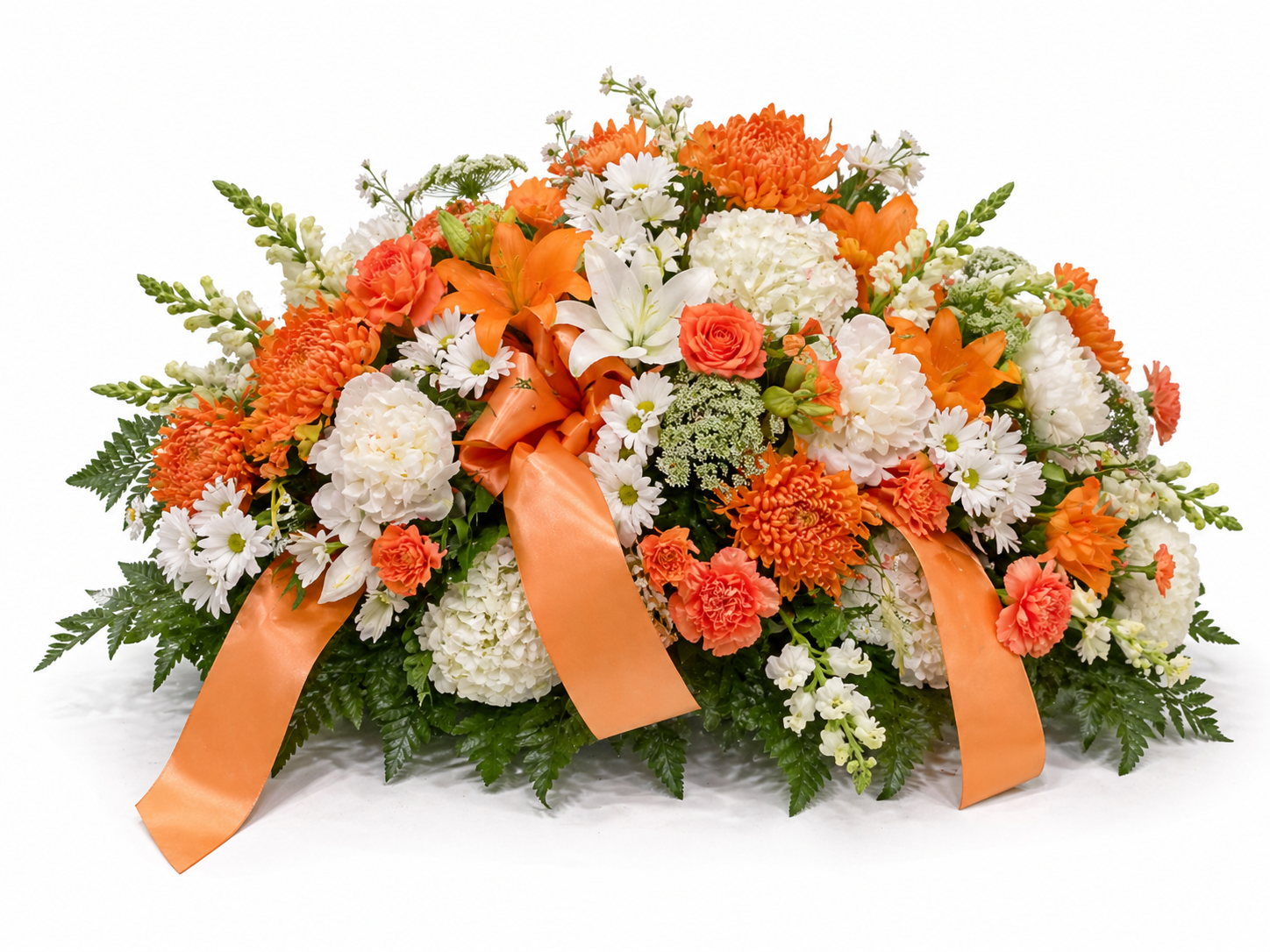 A floral arrangement with orange, white, and peach flowers, garnished with orange satin ribbons and green foliage.