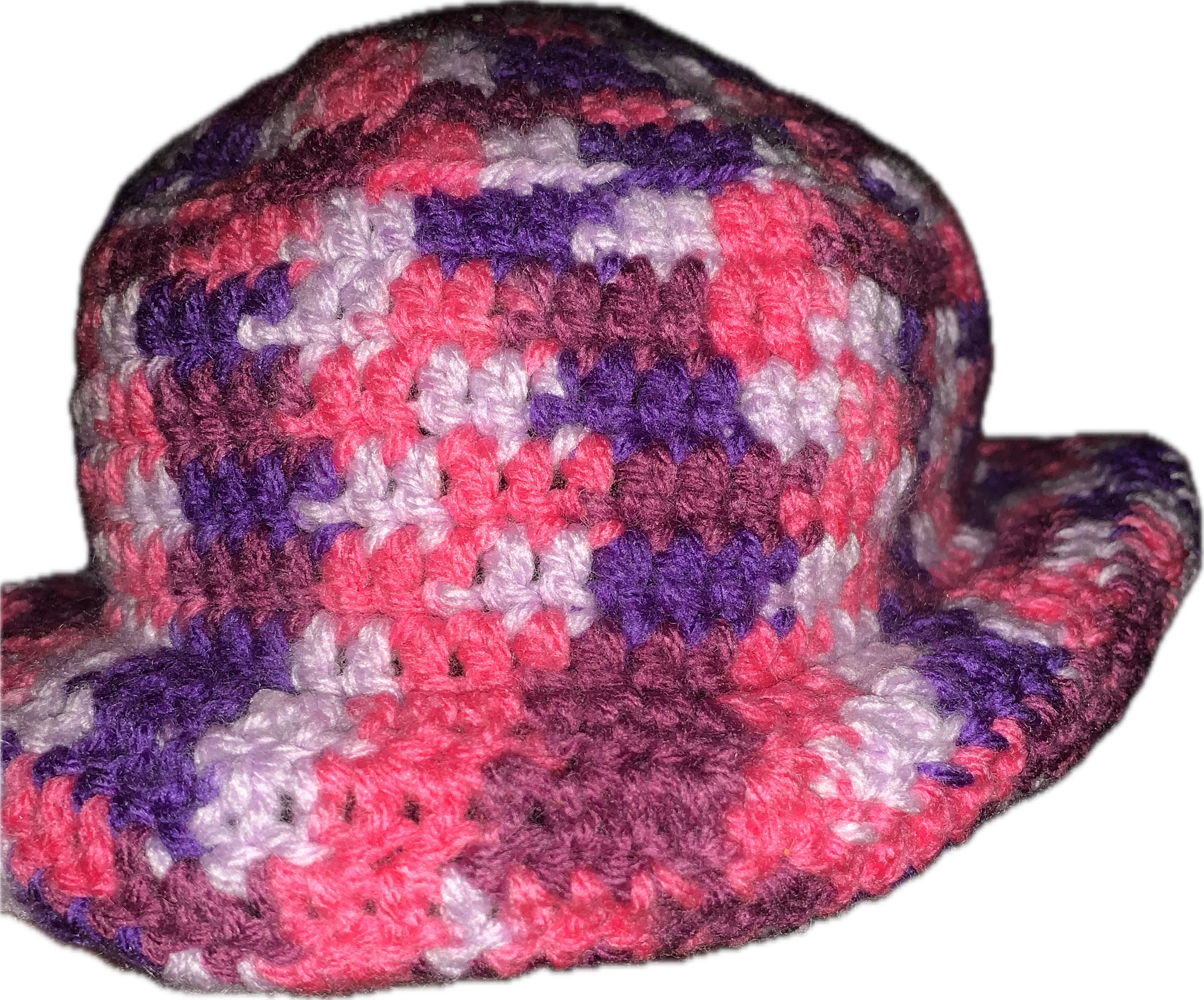 Colorful crocheted cowboy hat with pink, purple, white, and brown yarn, against a black background.