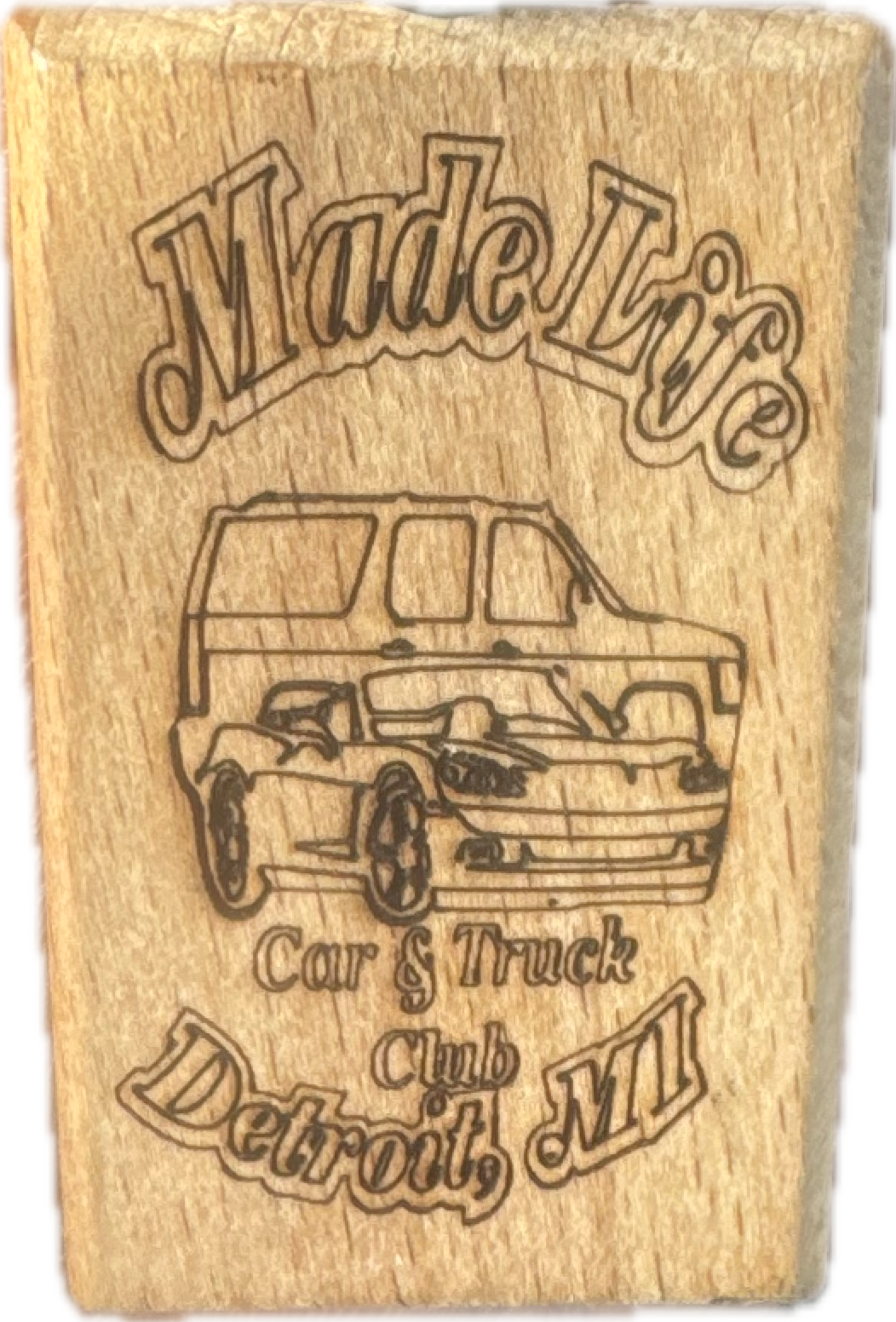 Wooden plaque with engraved outline of a car and text reading 'Made For' at the top, 'Car & Truck Club' below the car, and 'Detroit, MI' at the bottom.