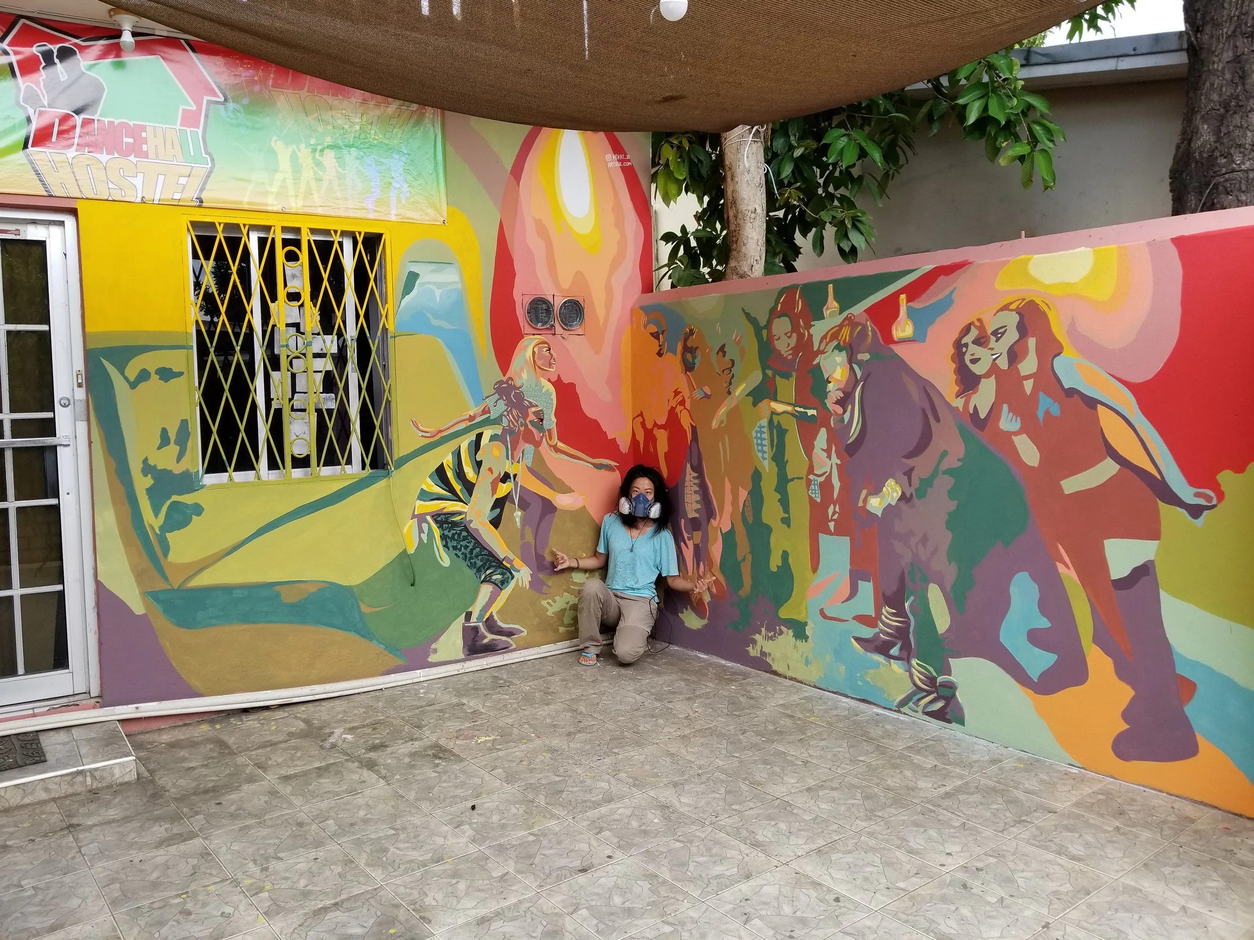 Created by Chinese artist HikkiTen. Colorful mural depicting Jamaican dancers dancing dancehall