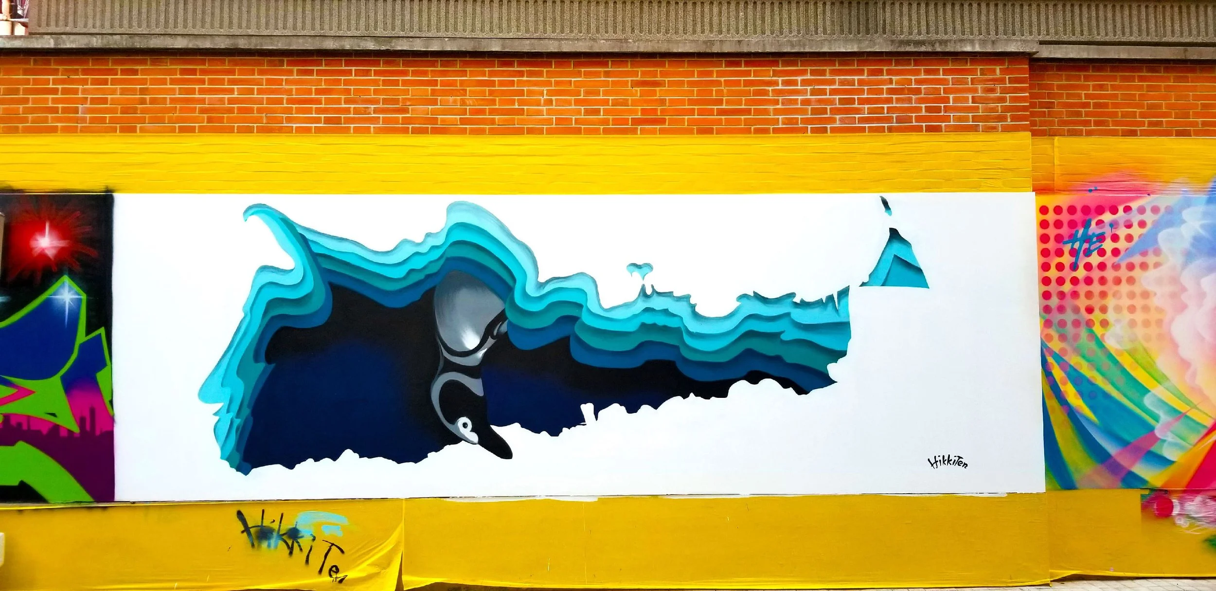 Created by Chinese artist HikkiTen. The art depicts an Argentinian Magellanic penguin digged hole all the way from Argentina to China (Argentina is the antipode of China on earth), to say Hi to Chinese audiences Happy New Year.