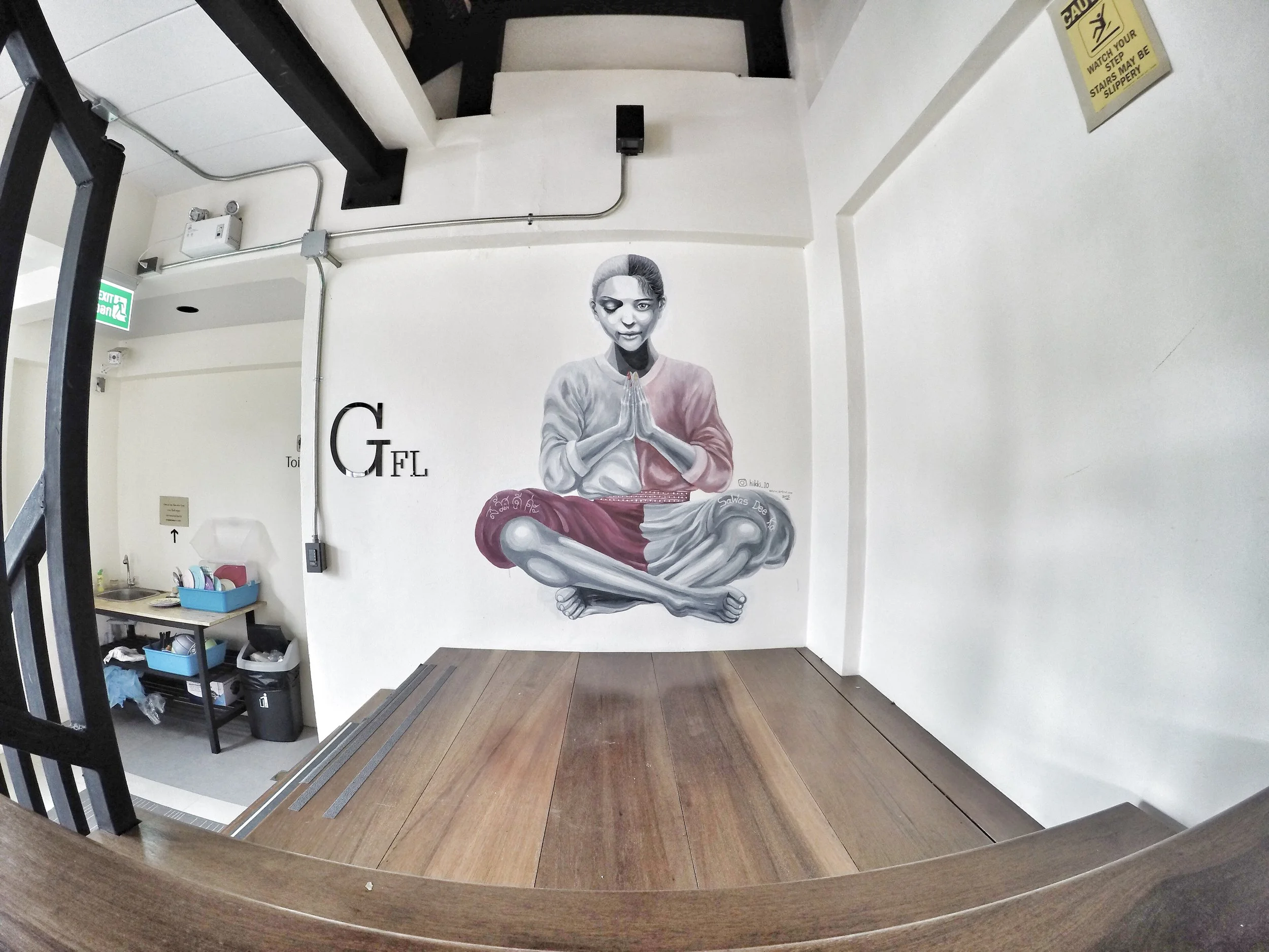 Created by Chinese artist HikkiTen. Mashup Murals of two persons in one with hands in prayer pose, Half farang and Half Thai