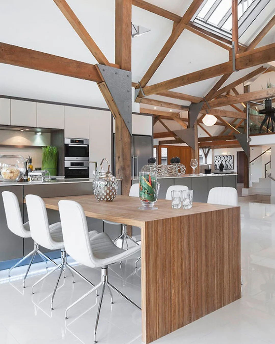 Original oak trusses, vaulted ceilings, endless character - and alongside it, handleless cabinetry, a walnut island and Miele appliances sitting flush within the architecture. Nothing competing. Everything considered.

Swipe to see the full commissio