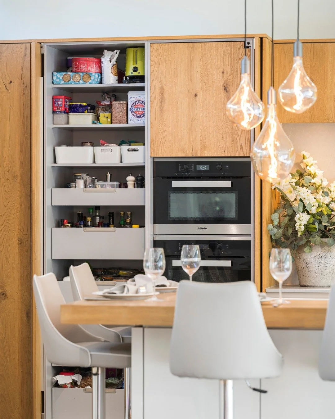 When a client asks for ovens that will still perform in twenty years, there is one answer.

Miele. Specified here as a full tower - oven, combination microwave and warming drawer - built flush into hand-painted cabinetry. The integration is seamless.