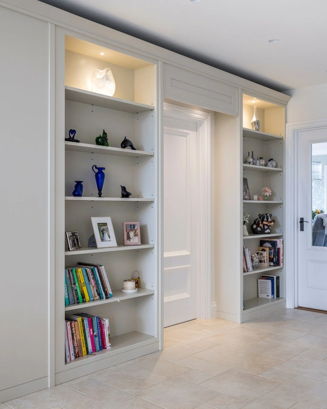 Did you know - we love kitchens, but we're an interior design studio that covers all areas of your home. 

This fitted unit runs the full height of the wall, framing the doorway and creating a sense of arrival. Our team builds units like this as furn
