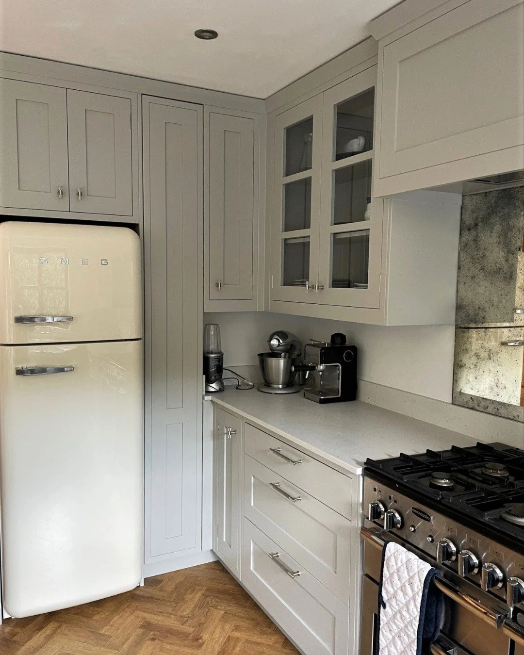 A classic in-frame kitchen with a range cooker, a Smeg fridge and a herringbone floor that ties the whole space together.

This project was designed for a family who wanted timeless over on-trend - cabinetry that would look as right in twenty years a