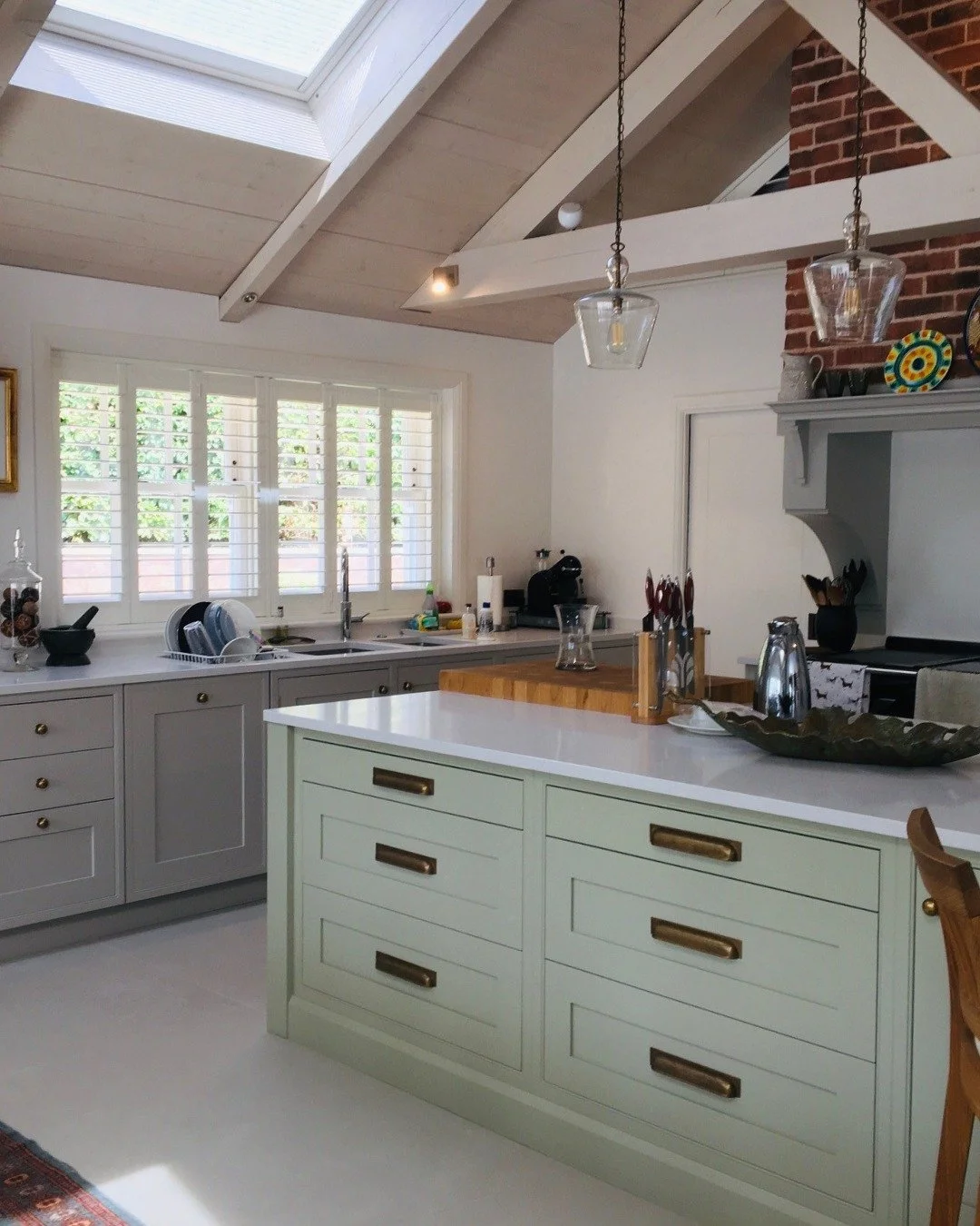 A lovely sage green kitchen and a brief that asked for warmth without fussiness.

Exposed rafters, skylights and a garden beyond the windows - this kitchen had to earn its place in a space already full of character. Our team specified sage green shak