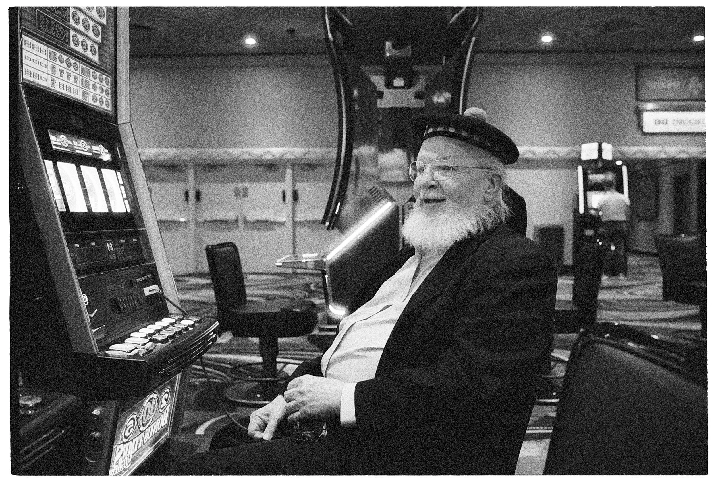 The penny slots are his second home. ha - Leica MP, 35mm Summilux, Ilford Delta 3200 