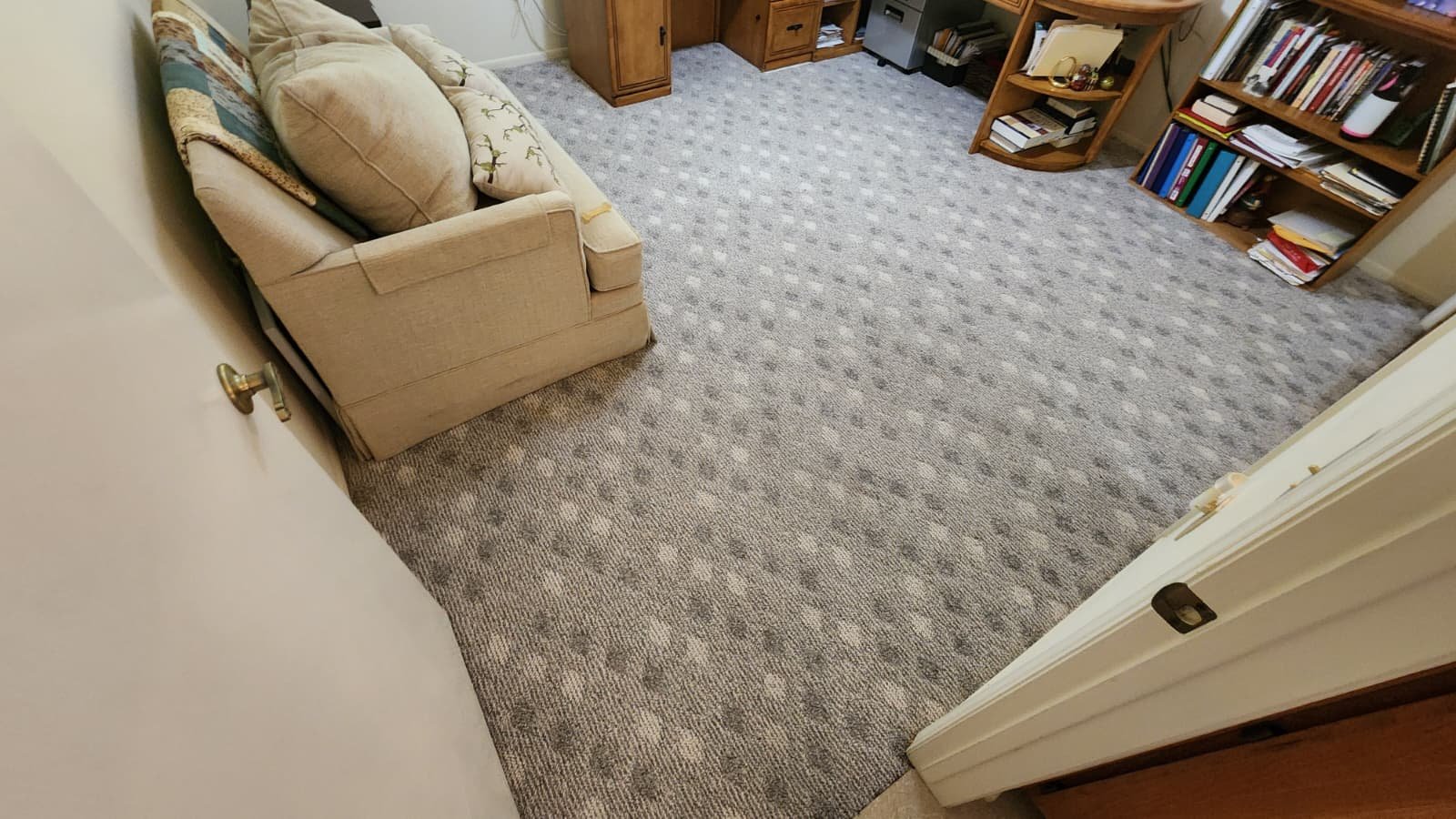 View of a living room with a beige couch after deep clean