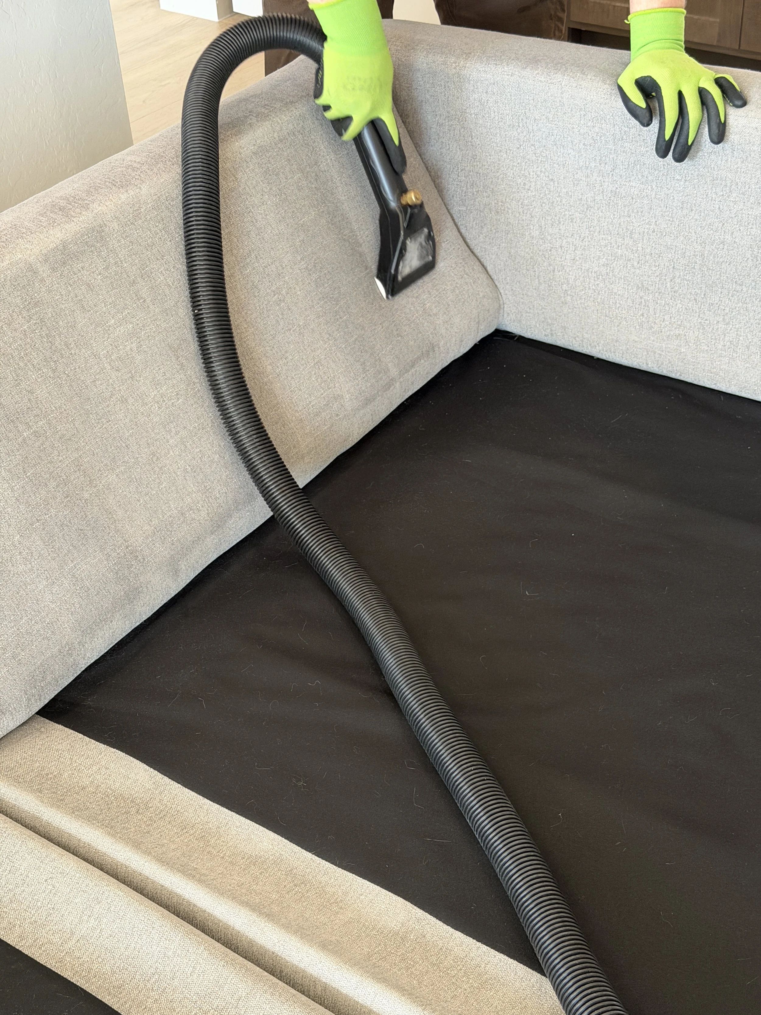 Deep cleaning steam machine used on a couch