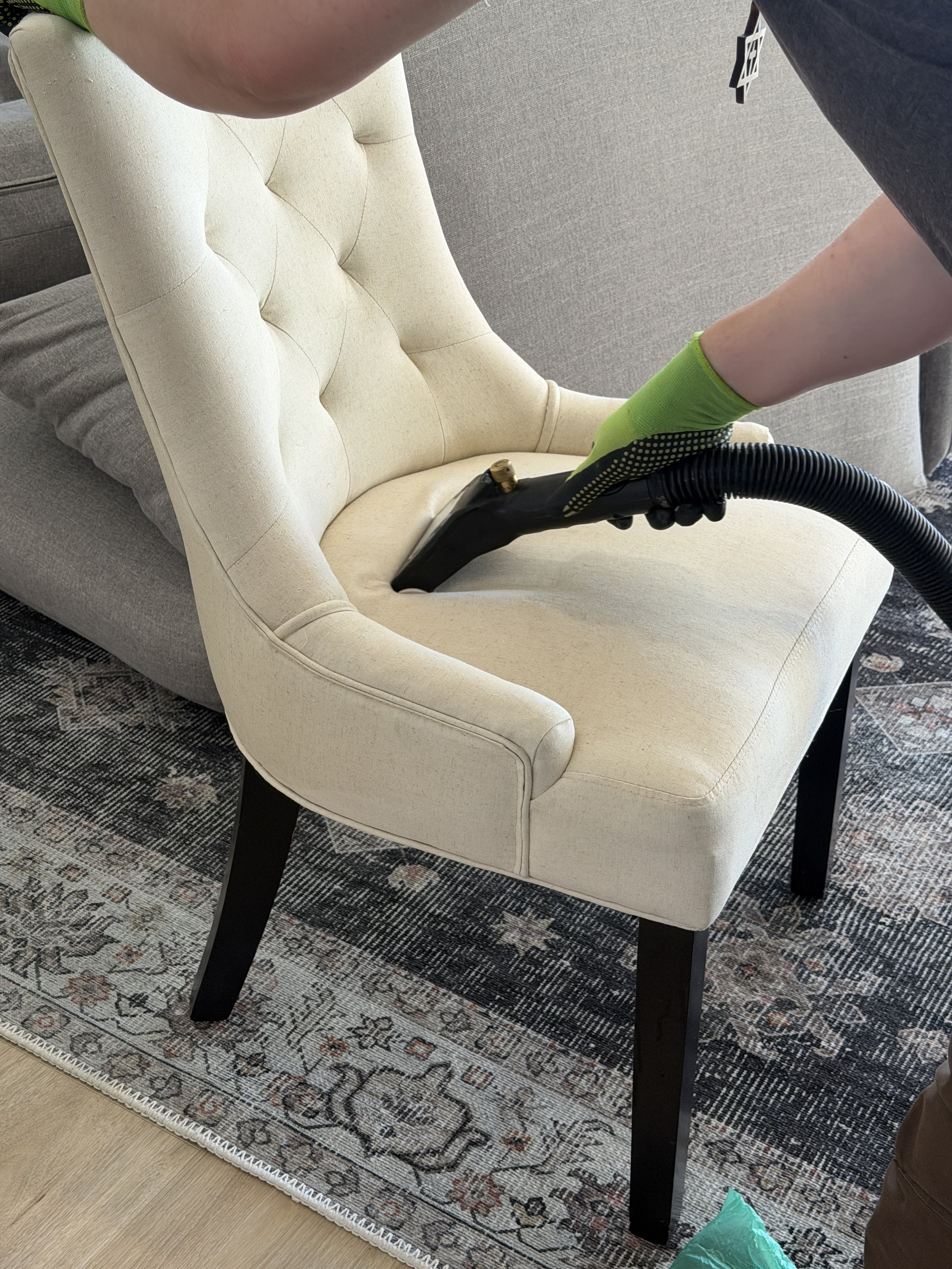 Deep cleaning steam machine used on a fabric chair