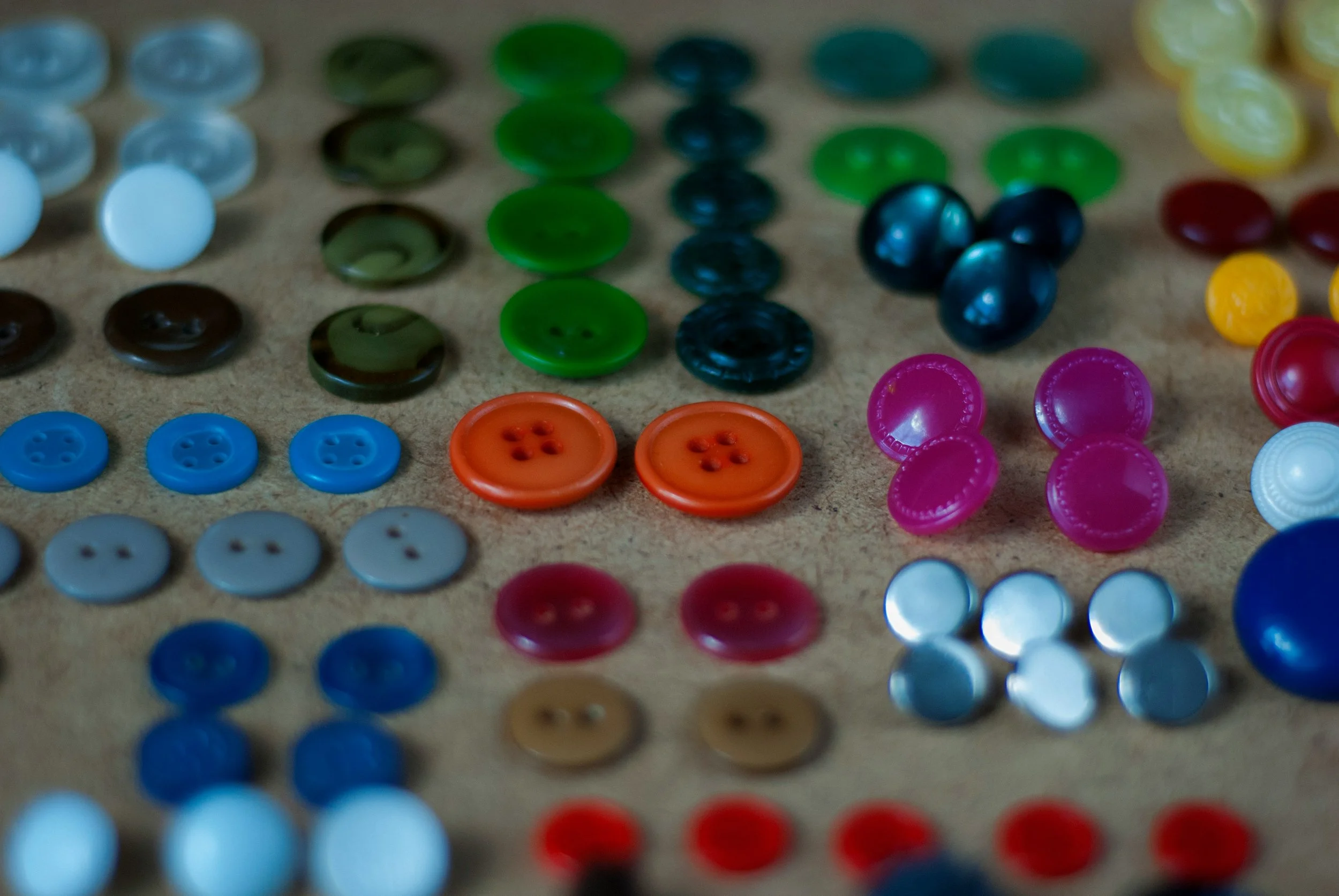 Close-up of multicolored buttons arranged on a surface.