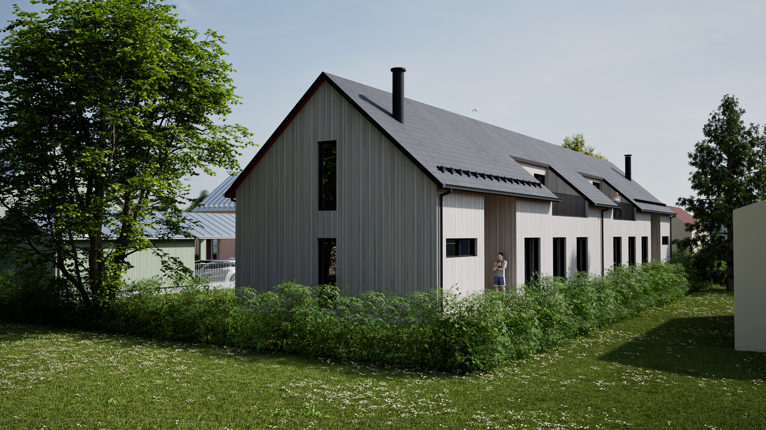 Moderni puutalo nurmikkoalueella ja puiden ympäröimänä.