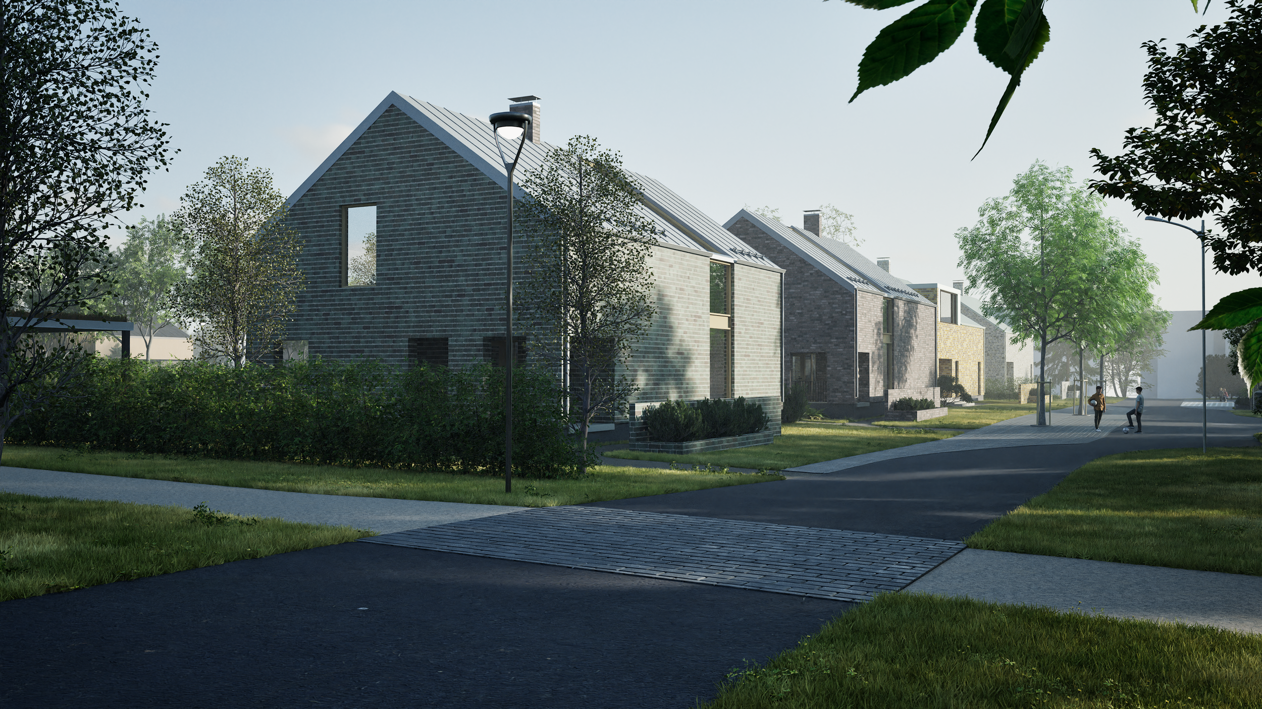 Kuvassa moderni asuinalue, jossa on rivitaloja ja kävelijöitä iltapäivällä tai aikaisin illalla, puita ja hyvin hoidettuja nurmikoita.