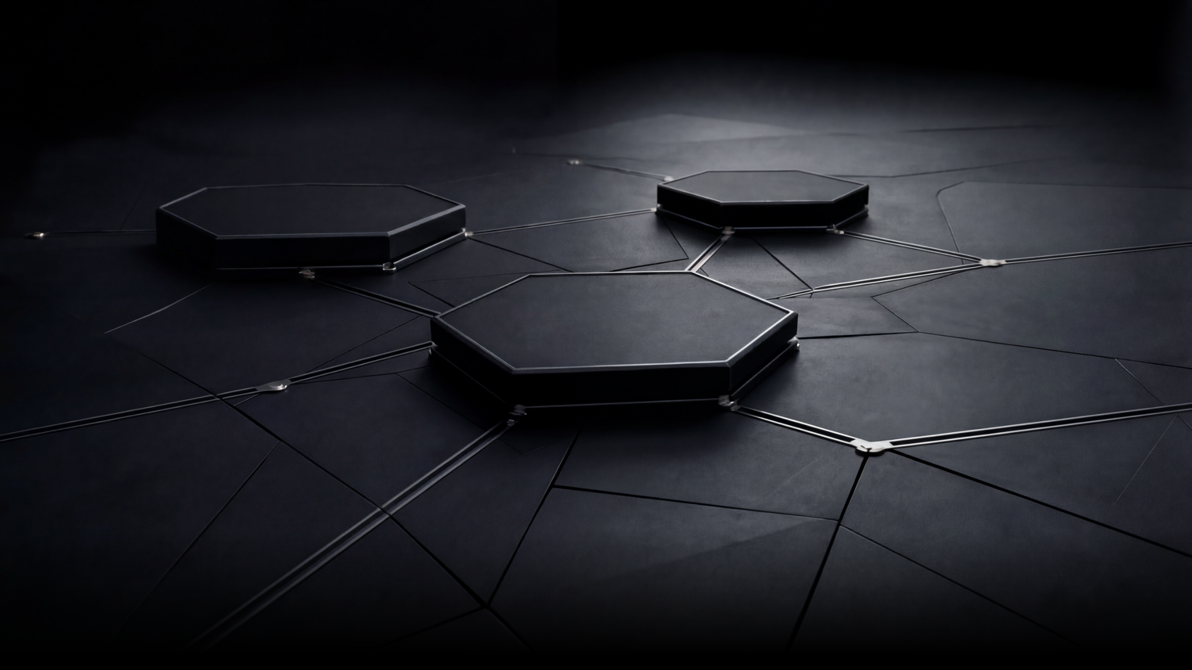 Close-up of a dark, modern device with hexagonal elements connected by lines on a black surface.