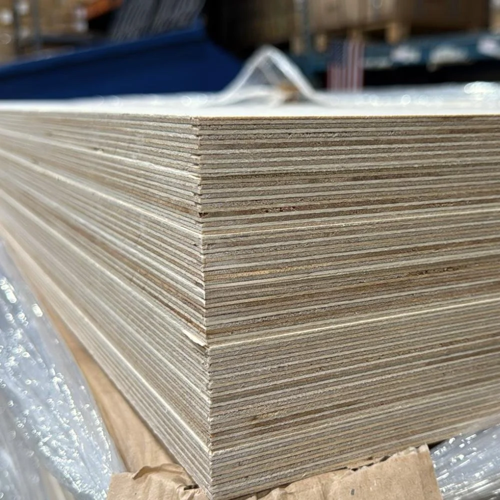 A large stack of plywood sheets in a warehouse.
