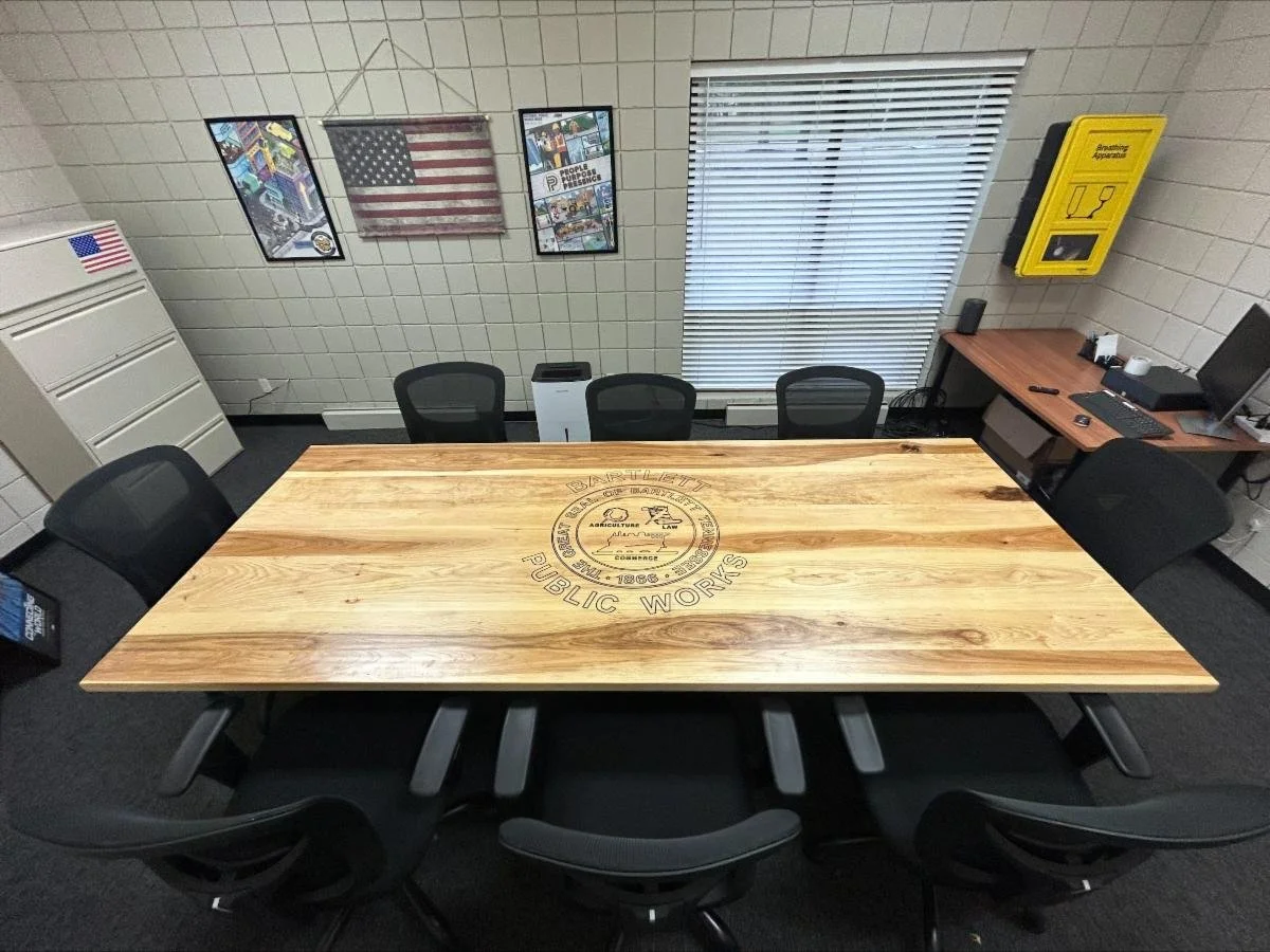 Conference room table with a seal, built by a woodworker from The Woodwork Shop. 