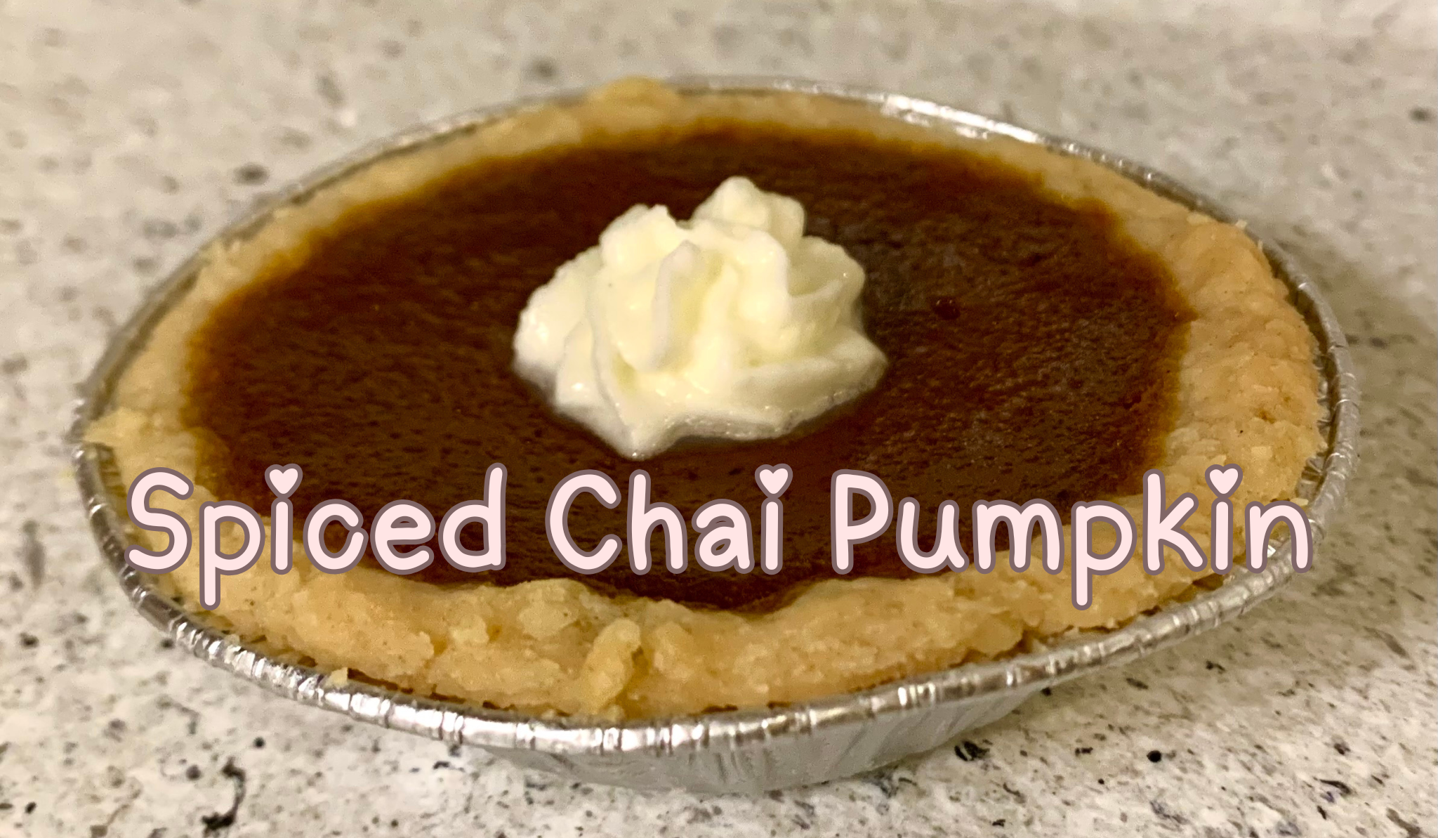 Mini spiced chai pumpkin pie with creamy pumpkin filling and topped with homemade whipped cream.