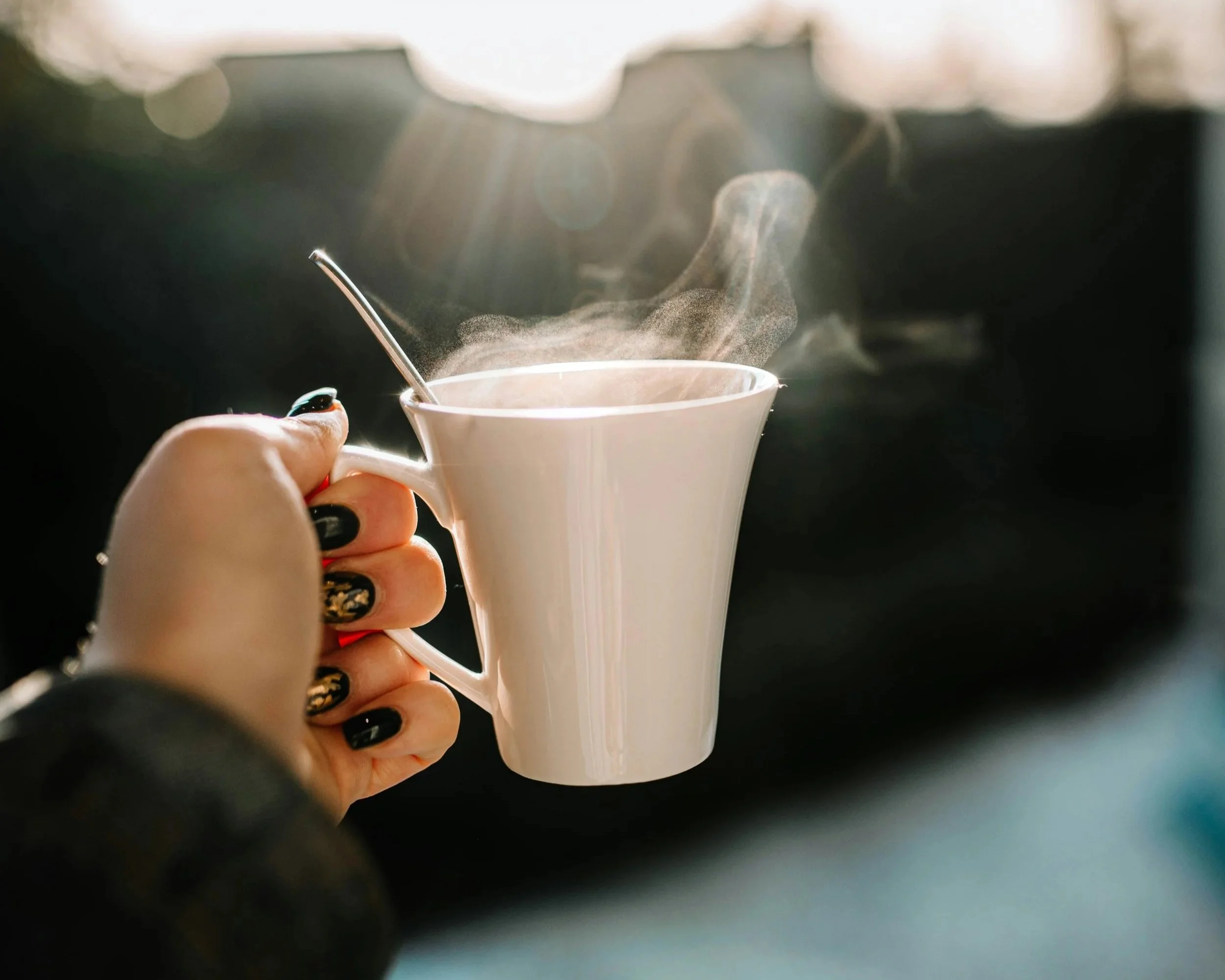 A woman holding a coffee cup while contemplating divorce.