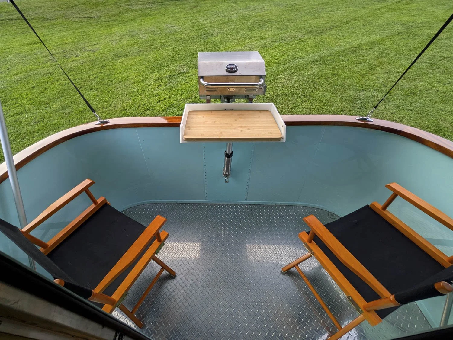 Aft Deck features pair of director’s chairs, and marine-style audio speakers along with floor drains.