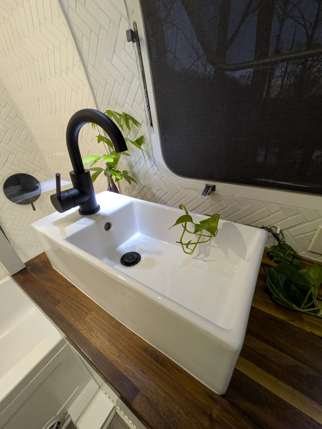 The Custom Modern Bathroom was designed to feel bright, comfortable, and functional with countertop space that works well for plants and personal touches.