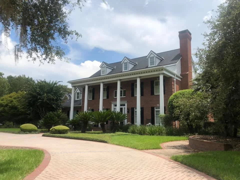 Large brick home with white bannisters. Reliable Painting Inc, Gainesville Florida