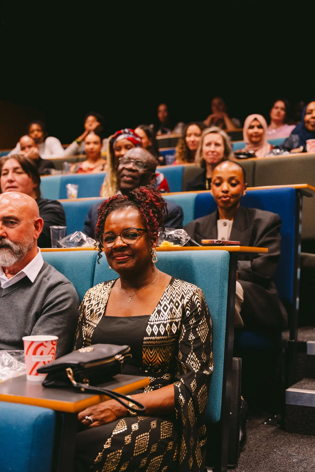 An audience attending a conference listening attentively.