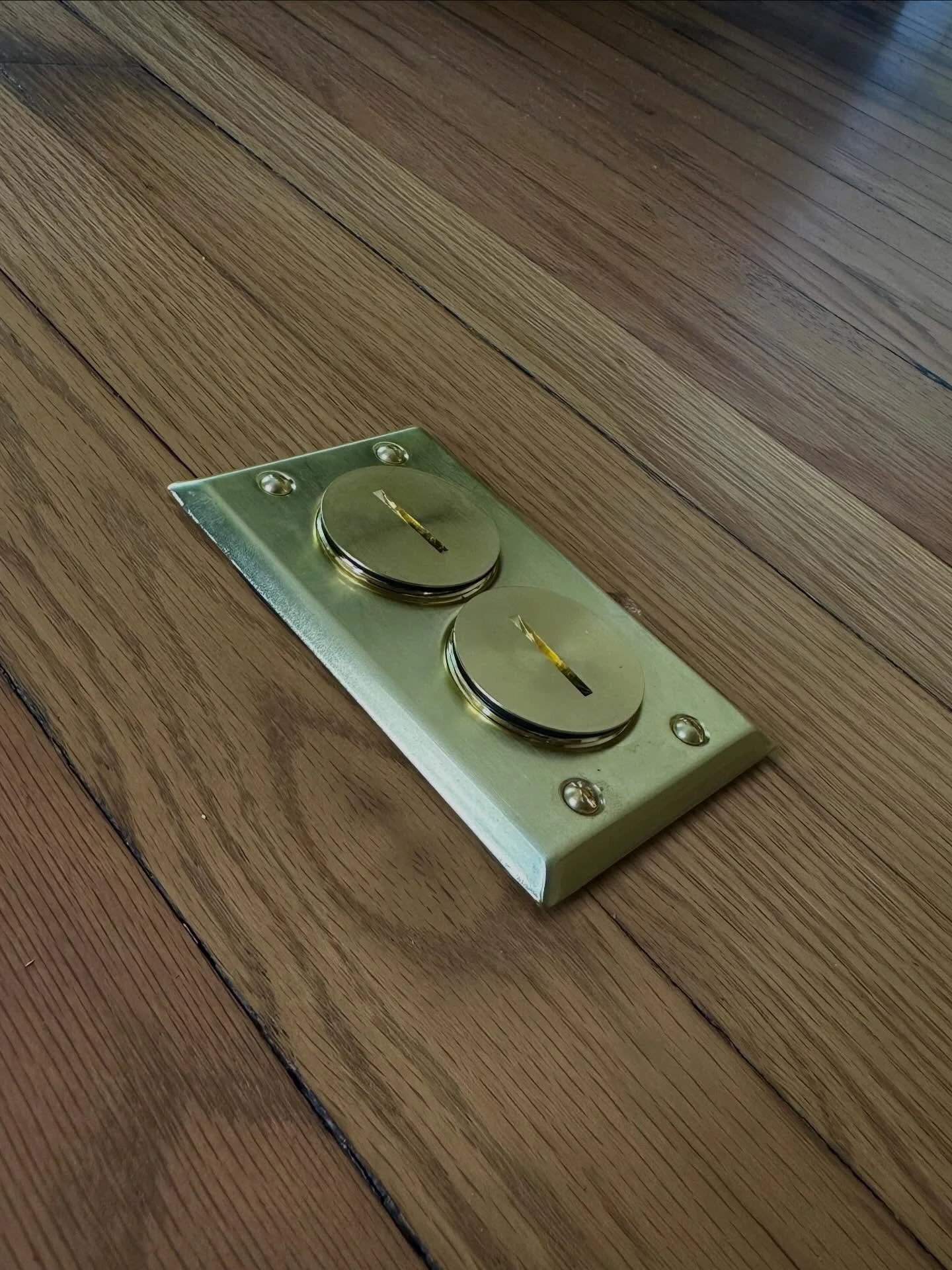 Flush mounted bronze floor outlet install, looking pretty. No more cords stretched across the room.