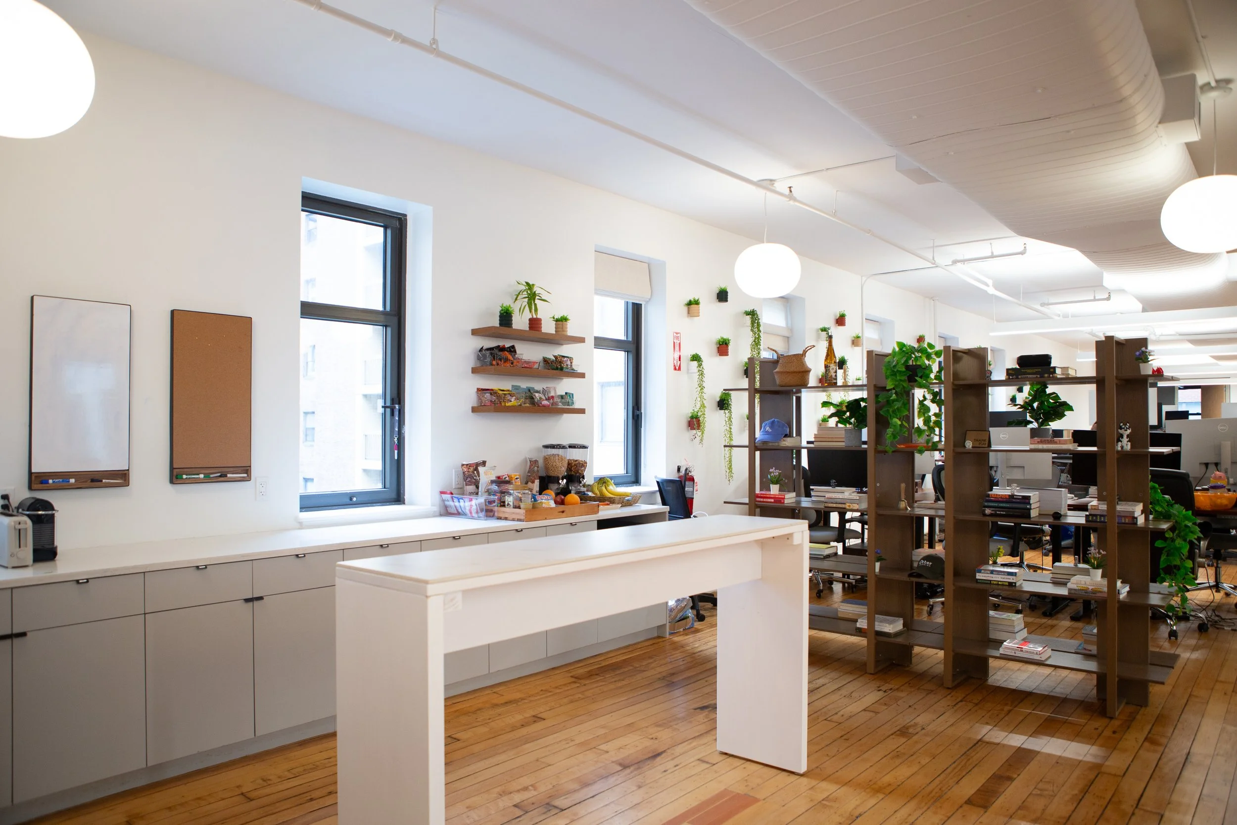 Flatiron Office's open kitchen showcases a spacious counter and organized shelves, ideal for culinary activities.