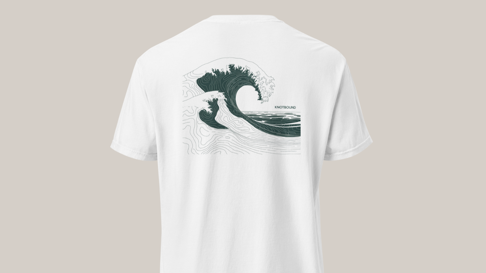 A white T-shirt with a graphic design of a large ocean wave and the word 'KNOTBOUND' printed on it.