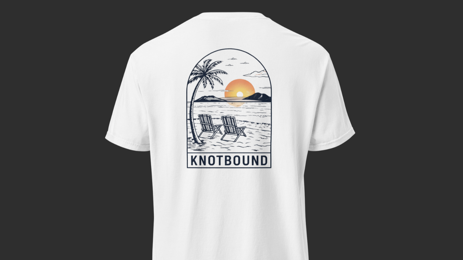 White T-shirt with a graphic of a beach scene, including two reclining chairs, a palm tree, and a sunset over the water, with the word "KNOTBOUND" below.
