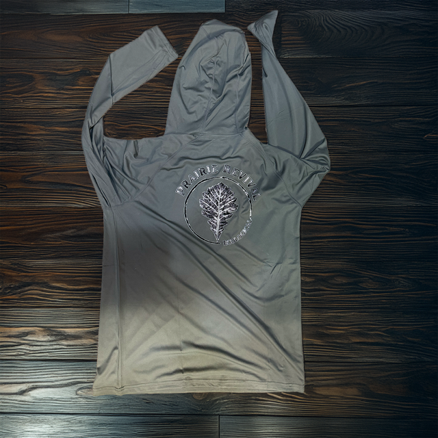 Front view of an olive green lightweight UPF performance sun hoodie featuring a custom left-chest Prairie Revival Ecological logo print.