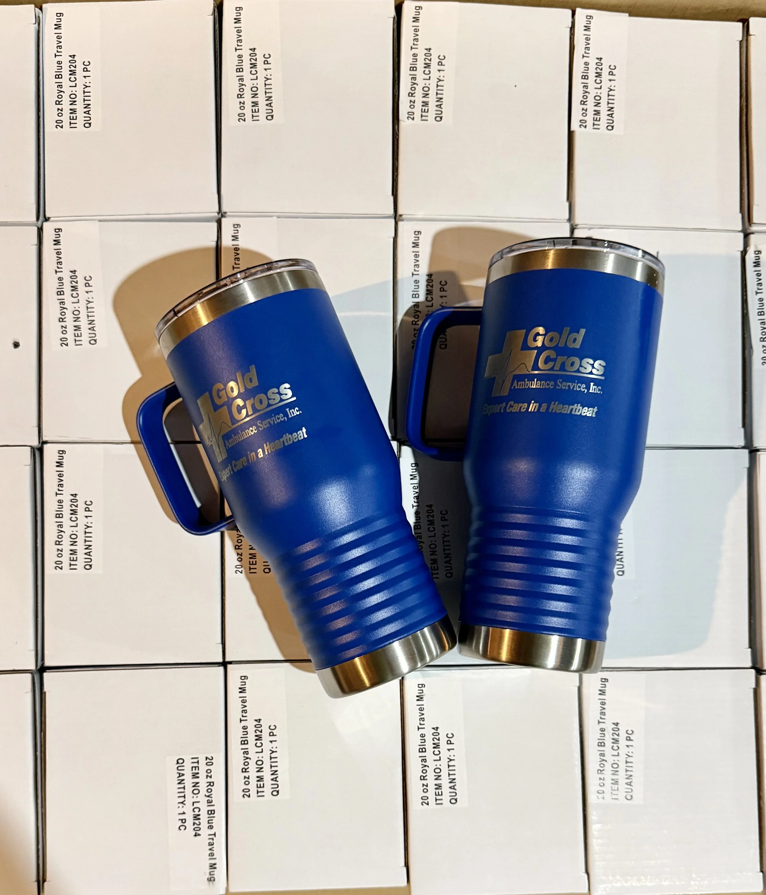 Custom laser-engraved performance mugs for Gold Cross Ambulance Service, produced by Nobleworks in Appleton, WI. High-durability branding for Fox Valley first responders featuring precision-etched logos.