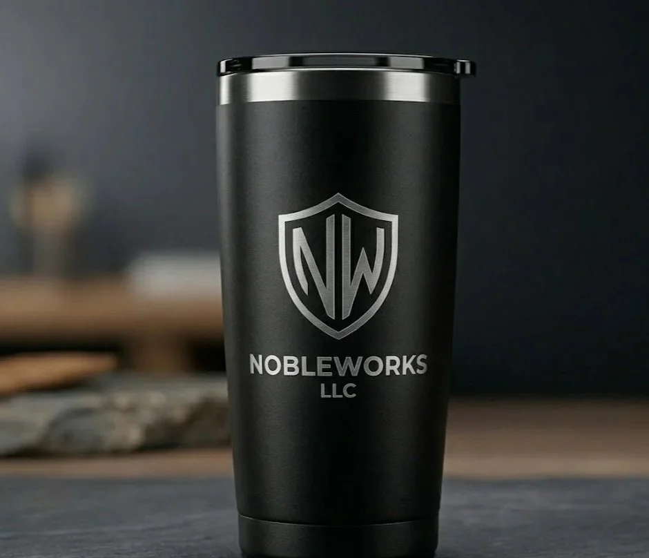 High-precision laser-engraved matte black tumbler featuring the NobleWorks LLC logo. Permanent stainless steel drinkware branding in Appleton, WI.