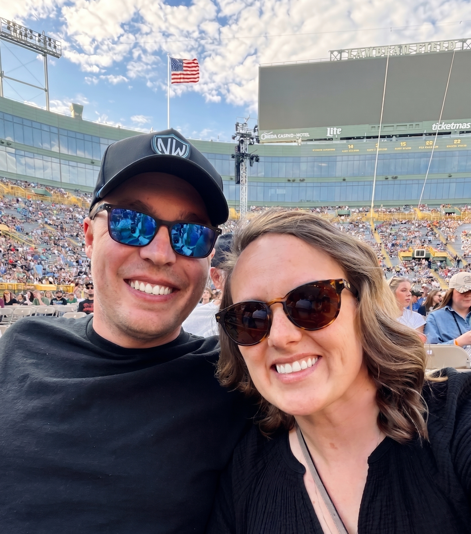 A smiling couple taking a selfie at the Luke Combs concert at Lambeau Field in Green Bay, Wisconsin on May 16, 2026.