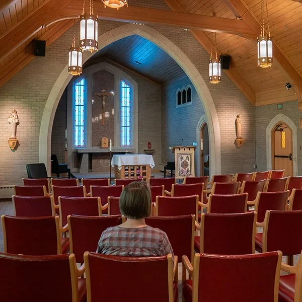 a lone retreatant praying in the chapel