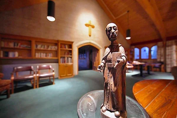 statue of st. ignatius of loyola in a library