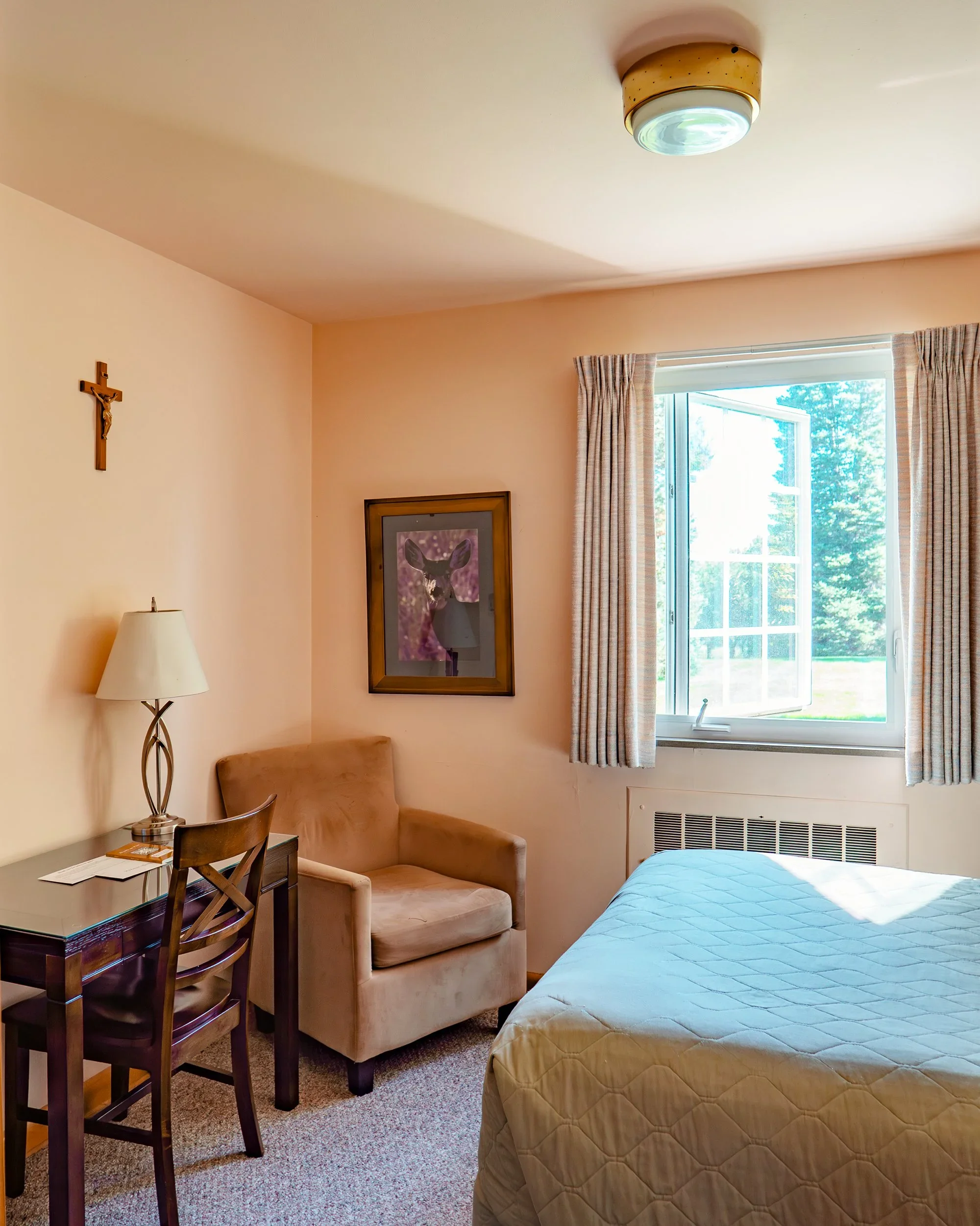 private bedroom with desk, chair and bed