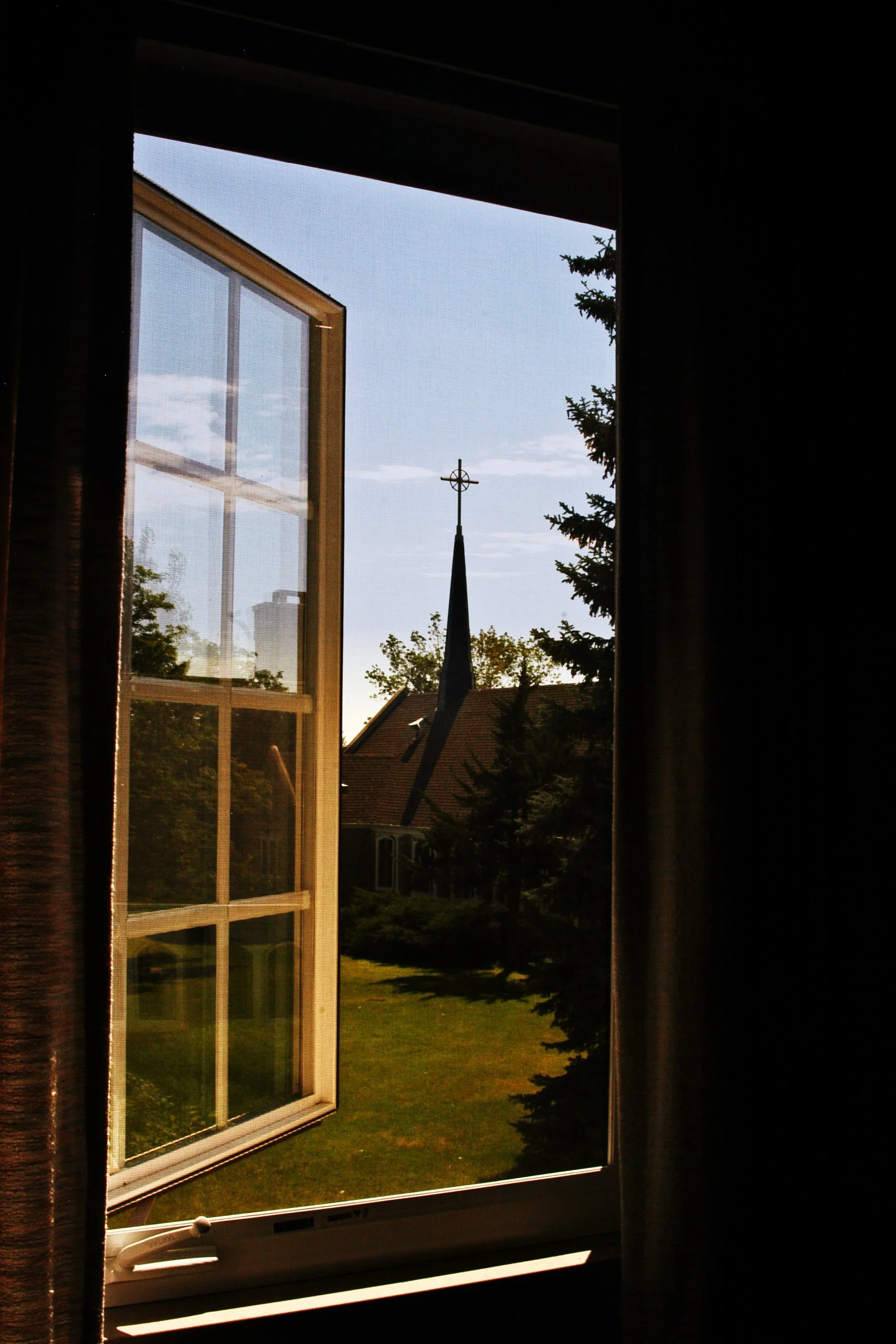 a church steeple through a window
