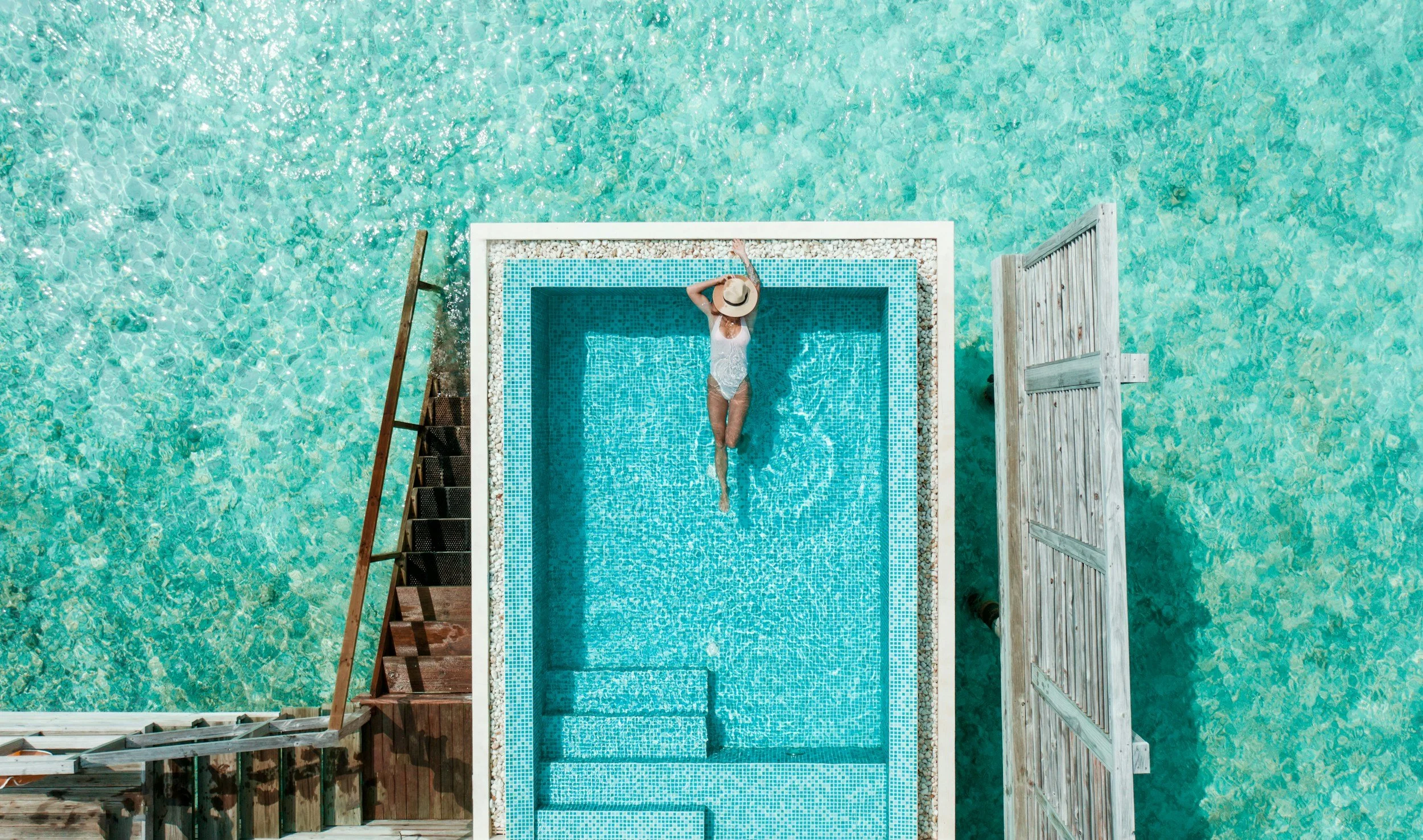 aerial shot of woman laying in the pool