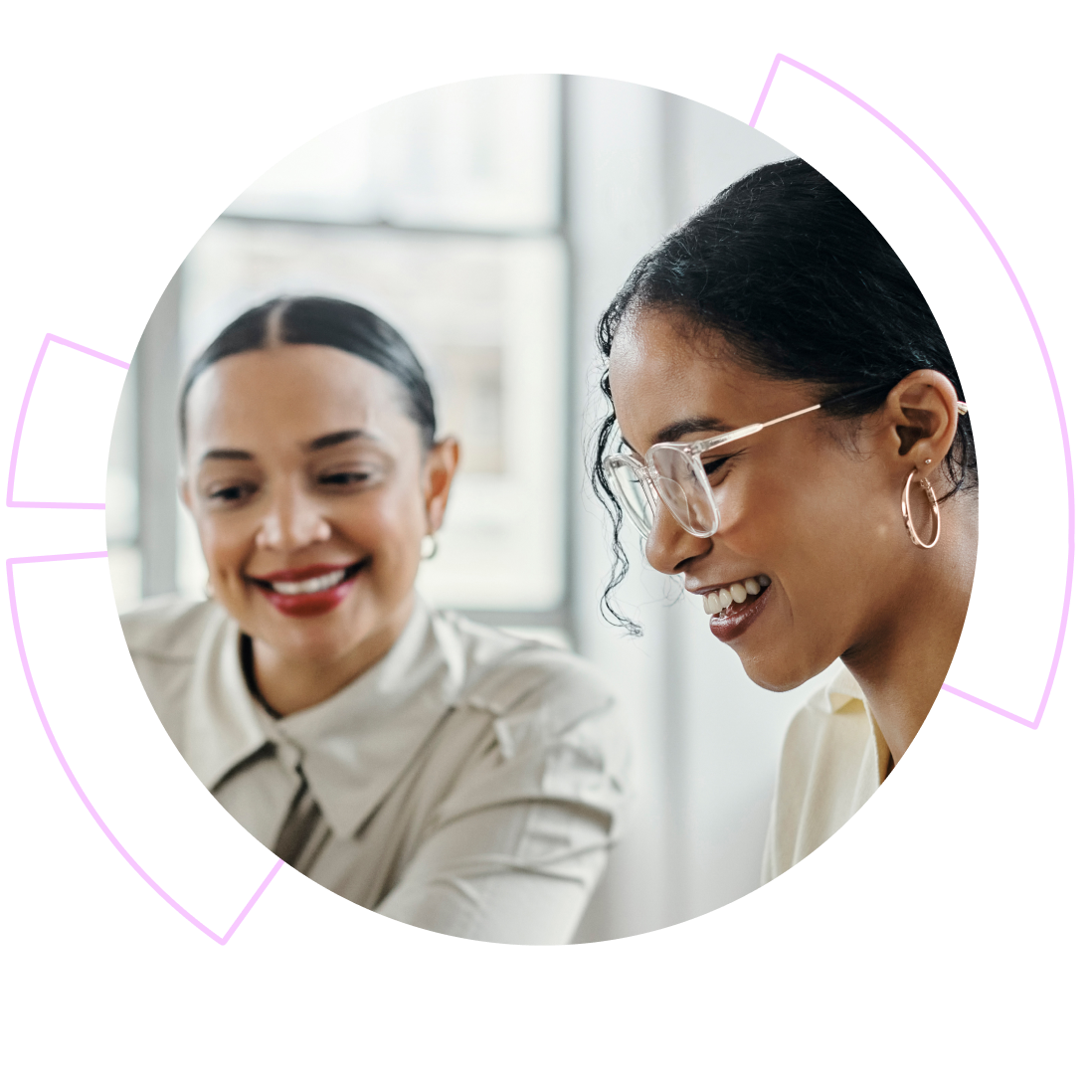 Two women smiling and having a conversation in a bright indoor setting, with one wearing glasses and earrings.