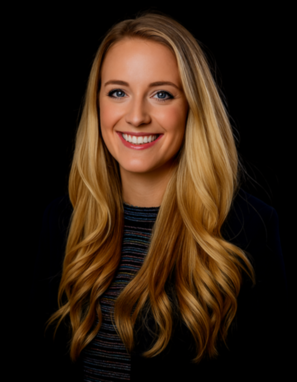 Headshot of a young woman with long blonde hair, blue eyes, and a bright smile, wearing a dark blazer and colorful striped top against a black background.