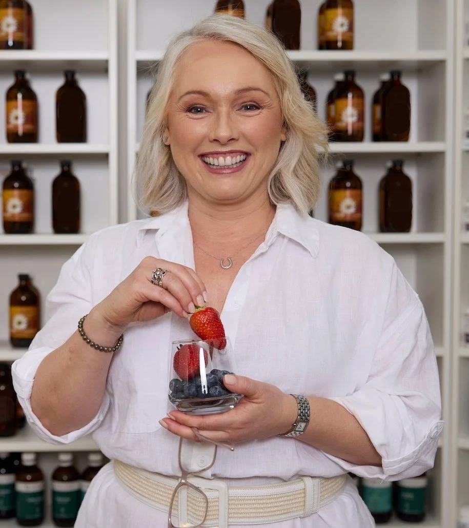 Clinical nutrition practitioner Melanie Makris holding personalised supplements at Paradigm Nutrition clinic in Bendigo Victoria