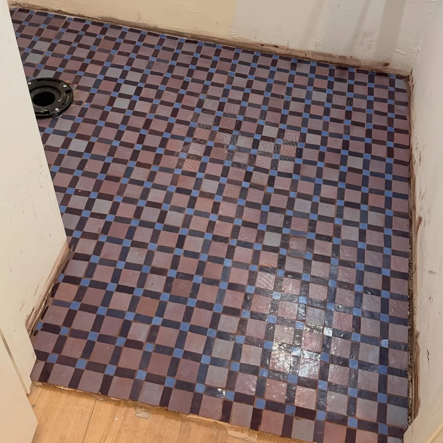 From sample to install! This zellige tile from @zia_tile is stunning and I cannot wait for this powder bath to be finished. We are doing a deep walnut wainscoting, floral wallpaper above, and antiqued brass hardware ✨