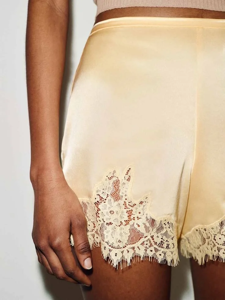 Fern Satin Short from Reformation, a mid-rise short with a relaxed fit and a lace hem