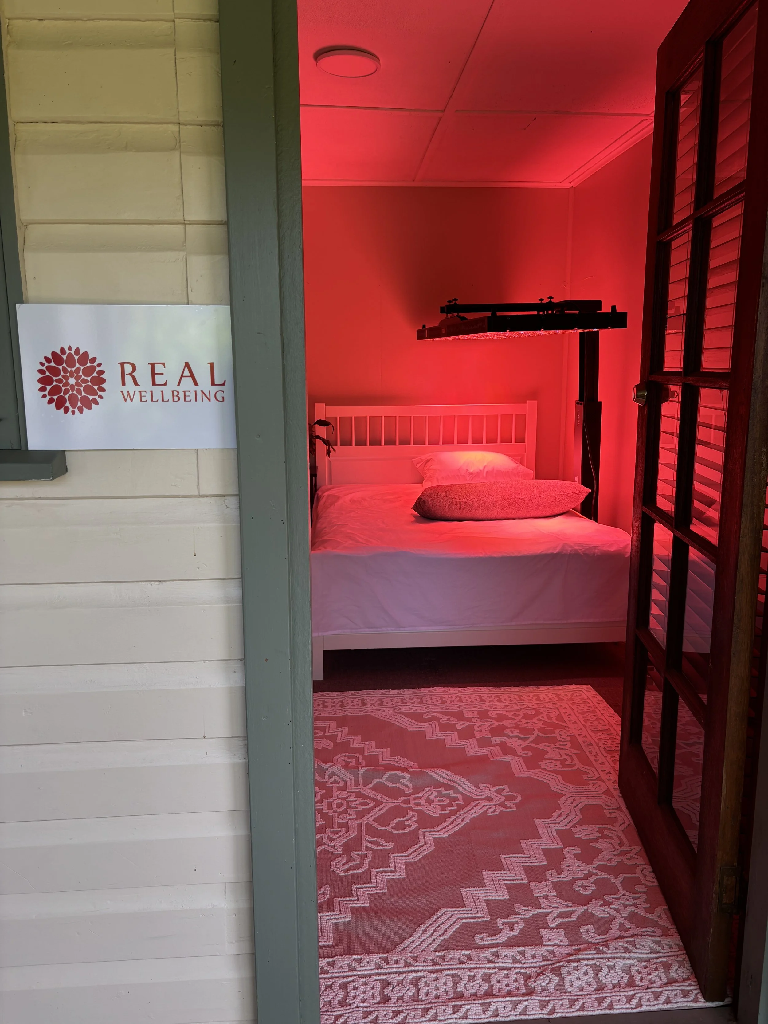 Real Wellbeing's wellness room for red light therapy and massage treatments in Pheasants Nest.