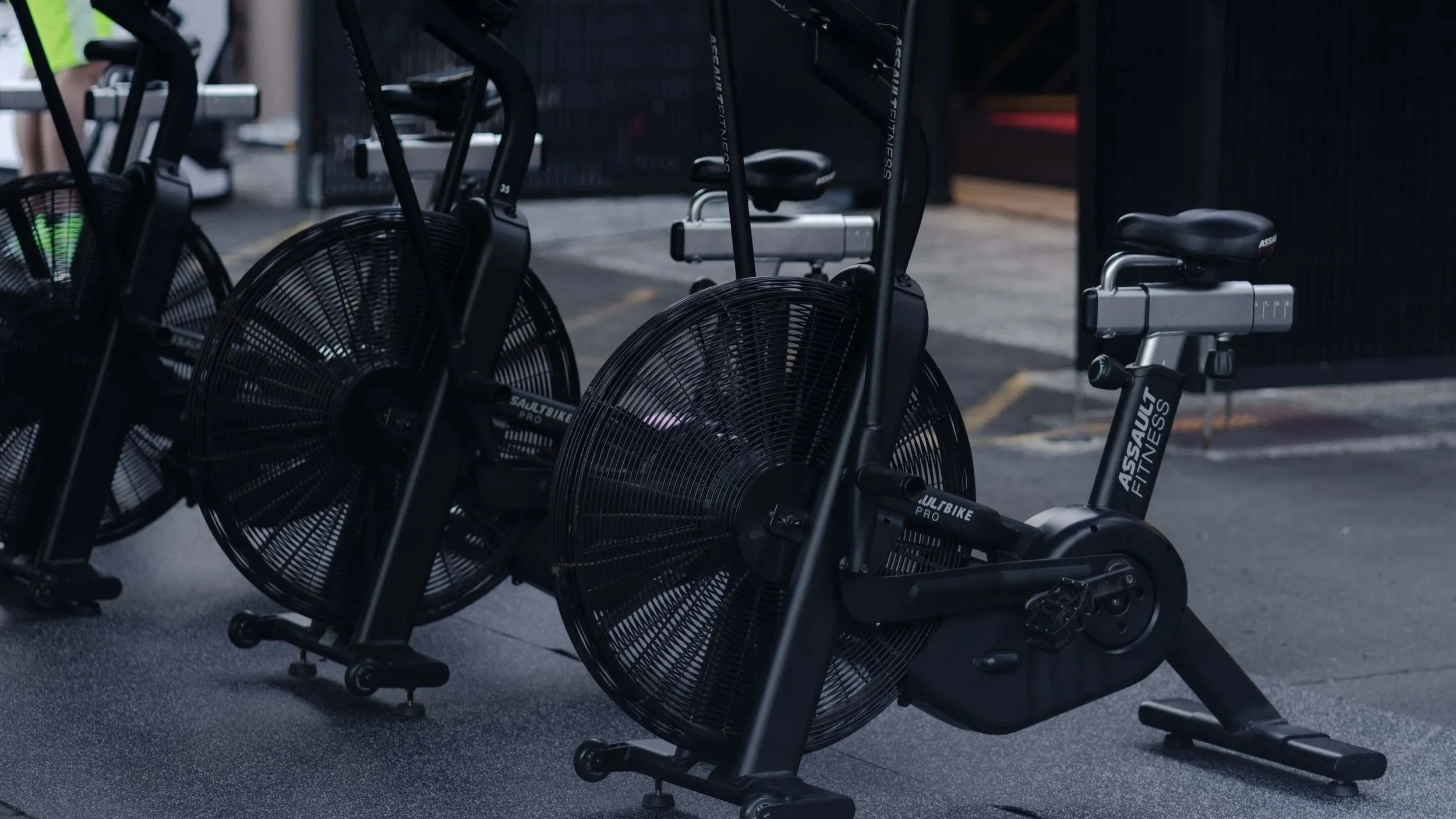 Black AssaultBikePRO exercise bike with fan wheel, pedals, and seat in a Les Mills Taranaki Street.